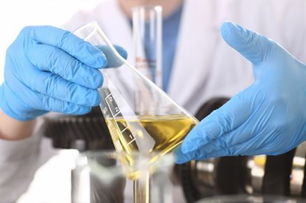 Close-up of a lab setup featuring Stimulant research chemicals in glass vials and test tubes.